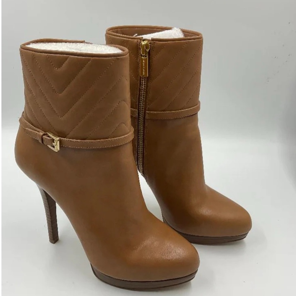 Tan leathered Michael Kors ankle boots.